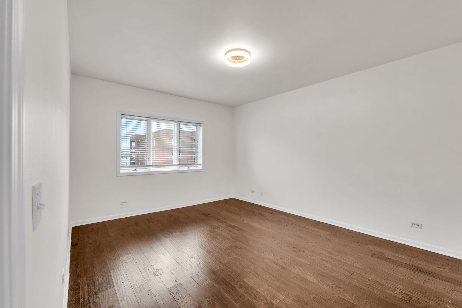 1330 Perry Street, Unit 504 Des Plaines, IL 60016 - Photo 15 of 32 an empty room with wooden floor and windows