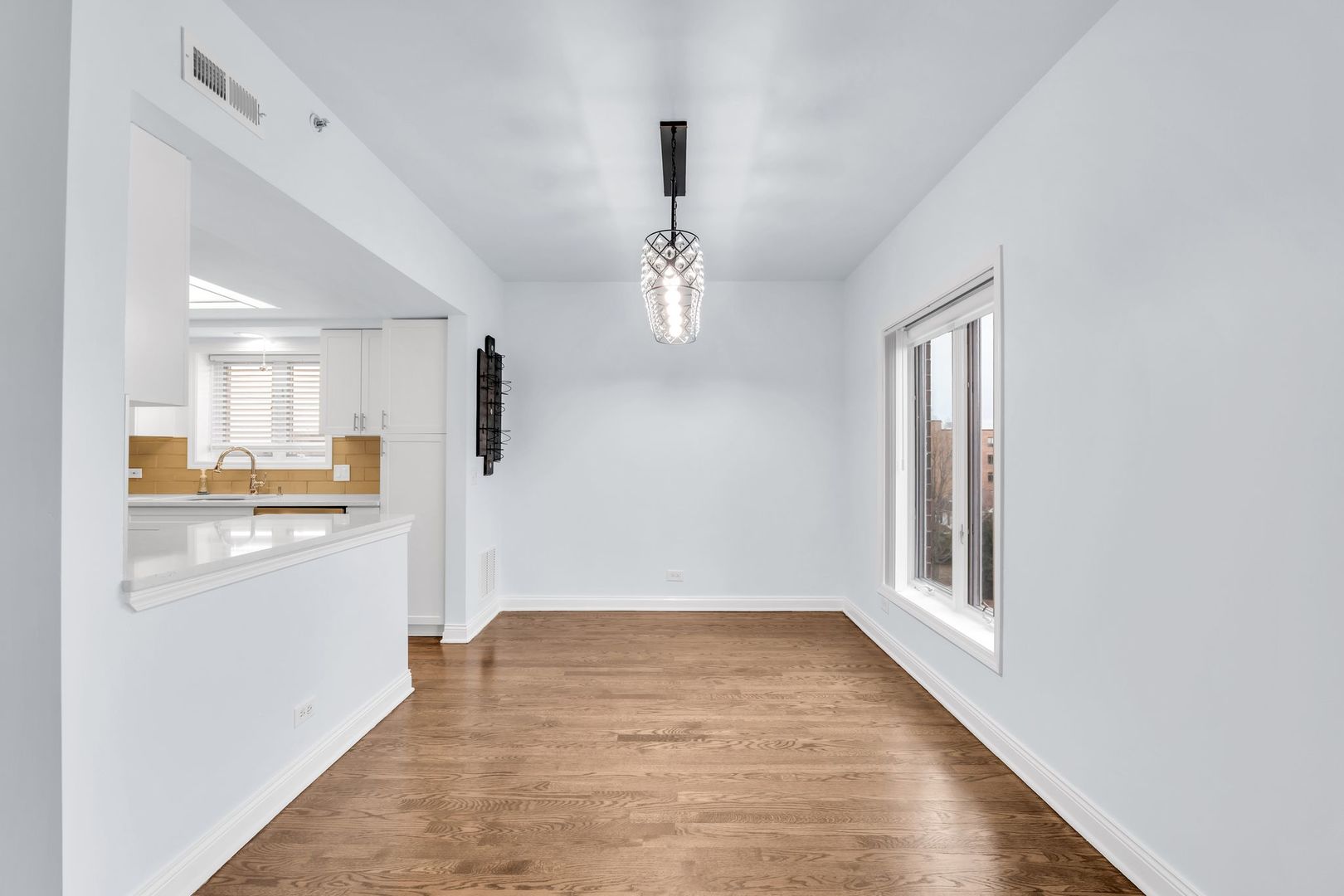 1330 Perry Street, Unit 504 Des Plaines, IL 60016 - Photo 7 of 32 a view of a hallway with wooden floor and a kitchen