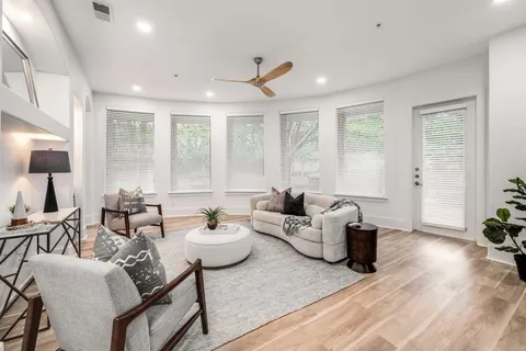 a living room with fireplace furniture and a wooden floor