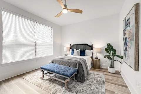 a bedroom with furniture and a window