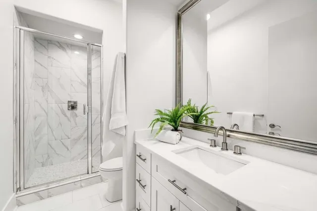 a bathroom with a sink a toilet and a mirror