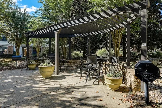 a view of a patio with table and chairs and wooden fence