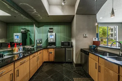 a kitchen with stainless steel appliances granite countertop a sink and cabinets