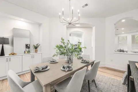 a view of a dining room with furniture and chandelier