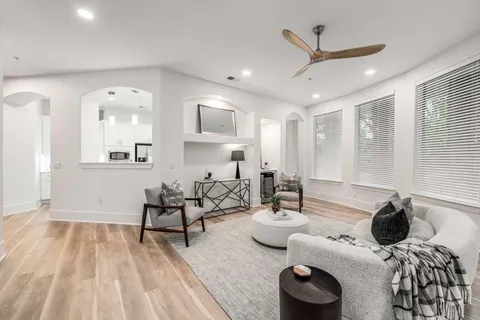 a living room with furniture and a wooden floor