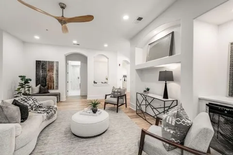 a living room with furniture and a wooden floor