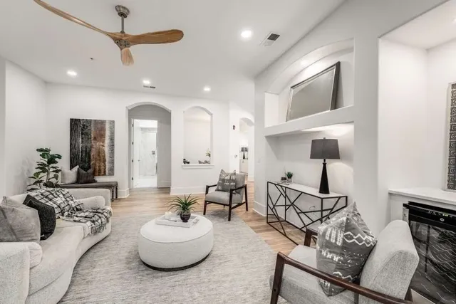 a living room with furniture and a wooden floor