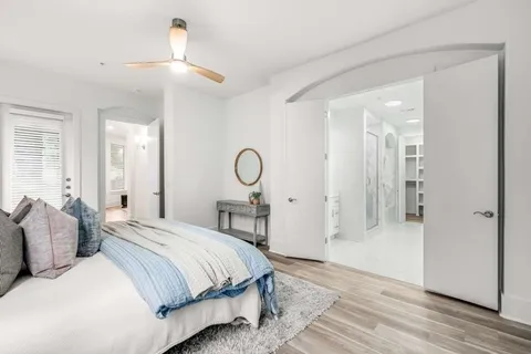 a bedroom with a bed and a chandelier