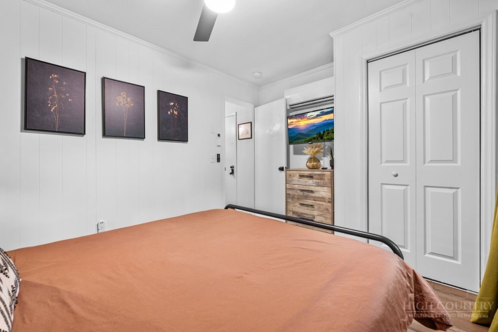 216 Saddle Lane Deep Gap, NC 28618 - Photo 14 of 44 a bedroom with a large bed and a painting on the wall