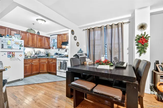 a kitchen with a table chairs stove and cabinets