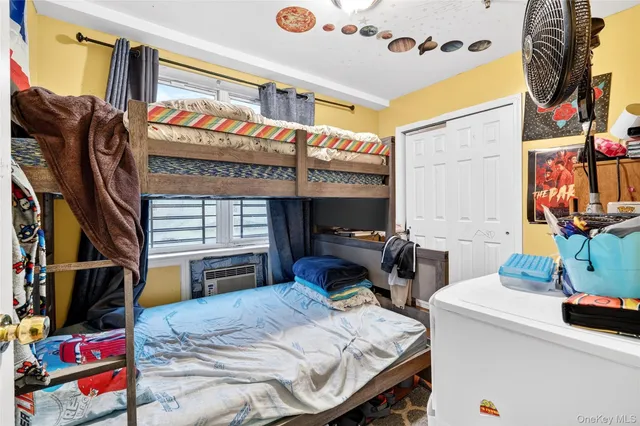 a bedroom with a bed and a tv