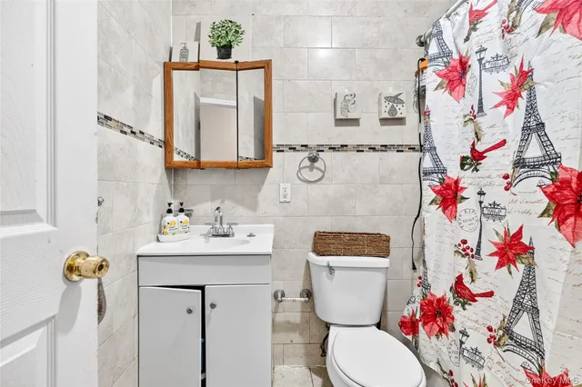 a bathroom with a sink mirror vanity and toilet