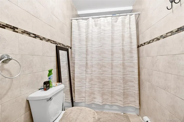 a bathroom with a sink a toilet and shower curtain