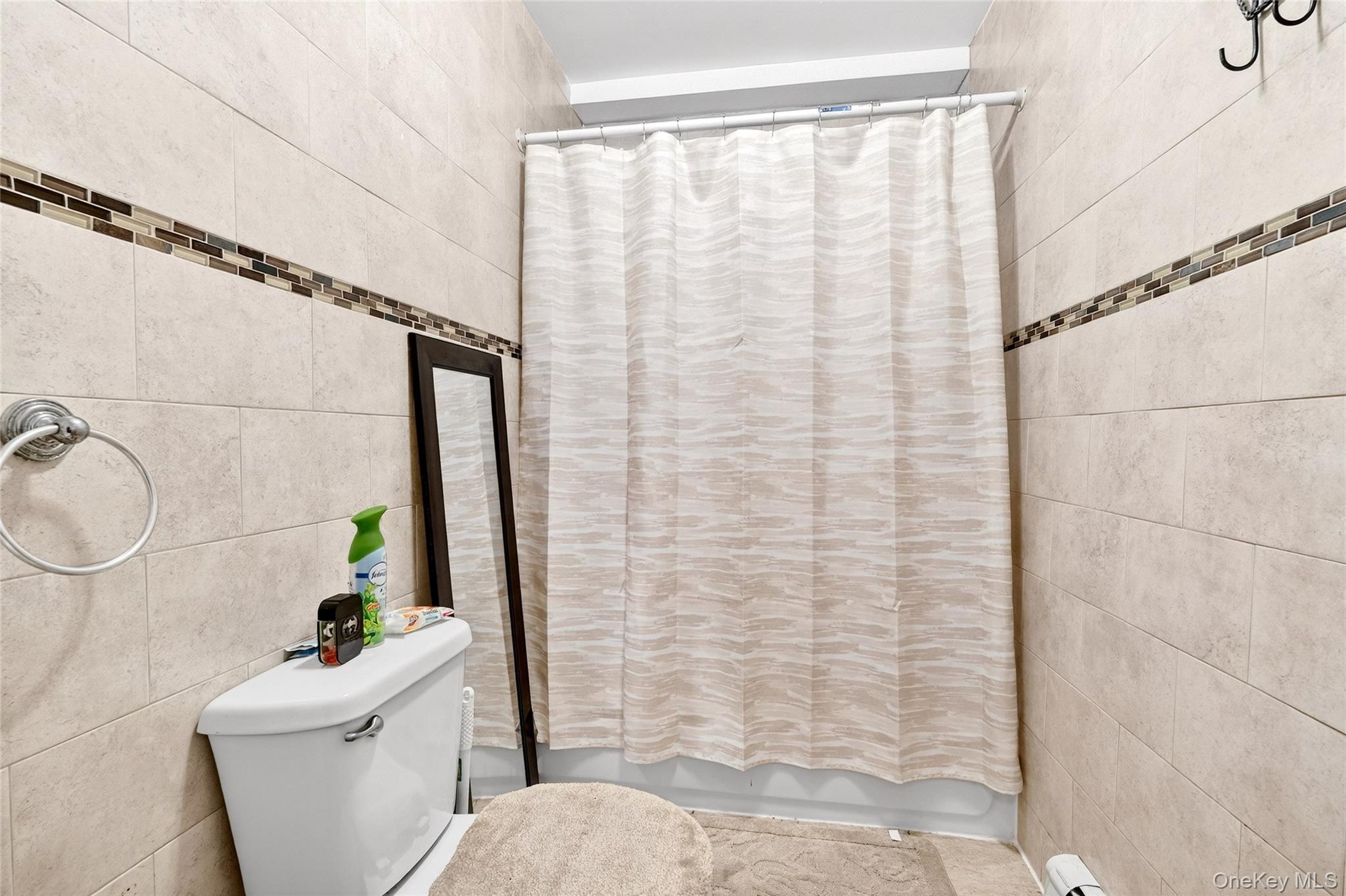 1459 Rosedale Avenue Bronx, NY 10460 - Photo 27 of 37 a bathroom with a sink a toilet and shower curtain