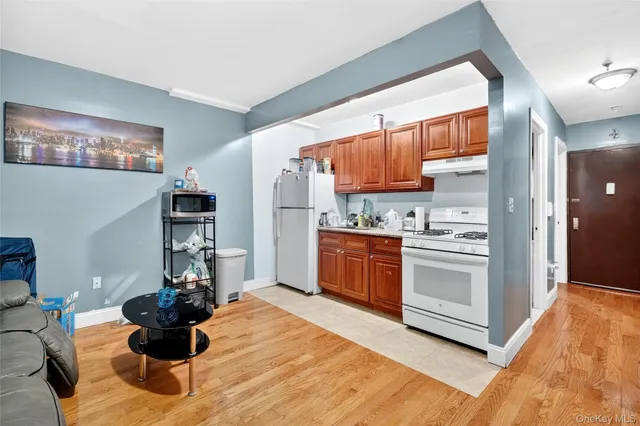 a kitchen with stainless steel appliances kitchen island granite countertop a refrigerator and a sink