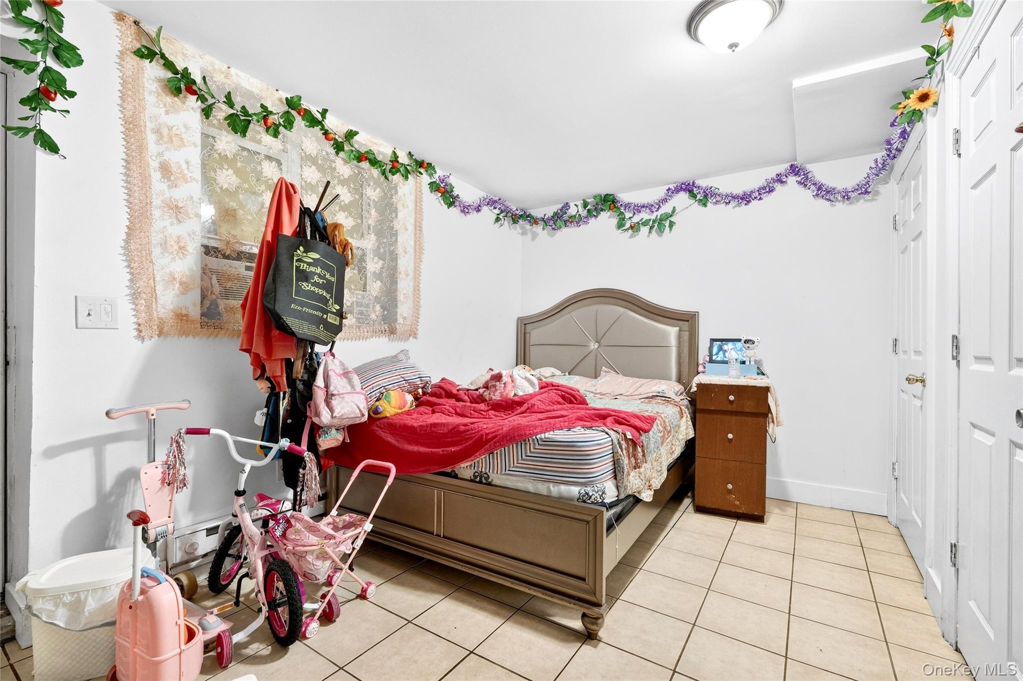 1459 Rosedale Avenue Bronx, NY 10460 - Photo 33 of 37 a bedroom with a bed and a chandelier