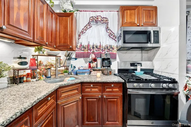 a kitchen with stainless steel appliances granite countertop a stove and a sink