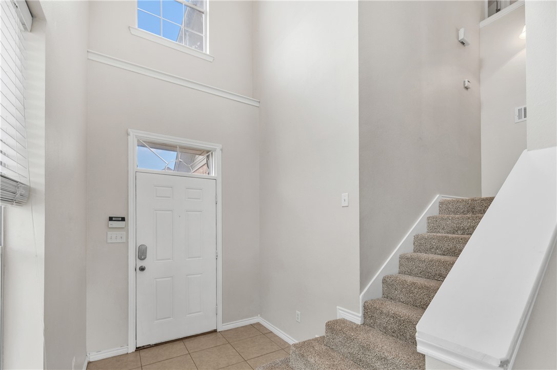 1425 West Villa Maria Road, Unit 1004 Bryan, TX 77801 - Photo 14 of 23 a view of staircase with white walls