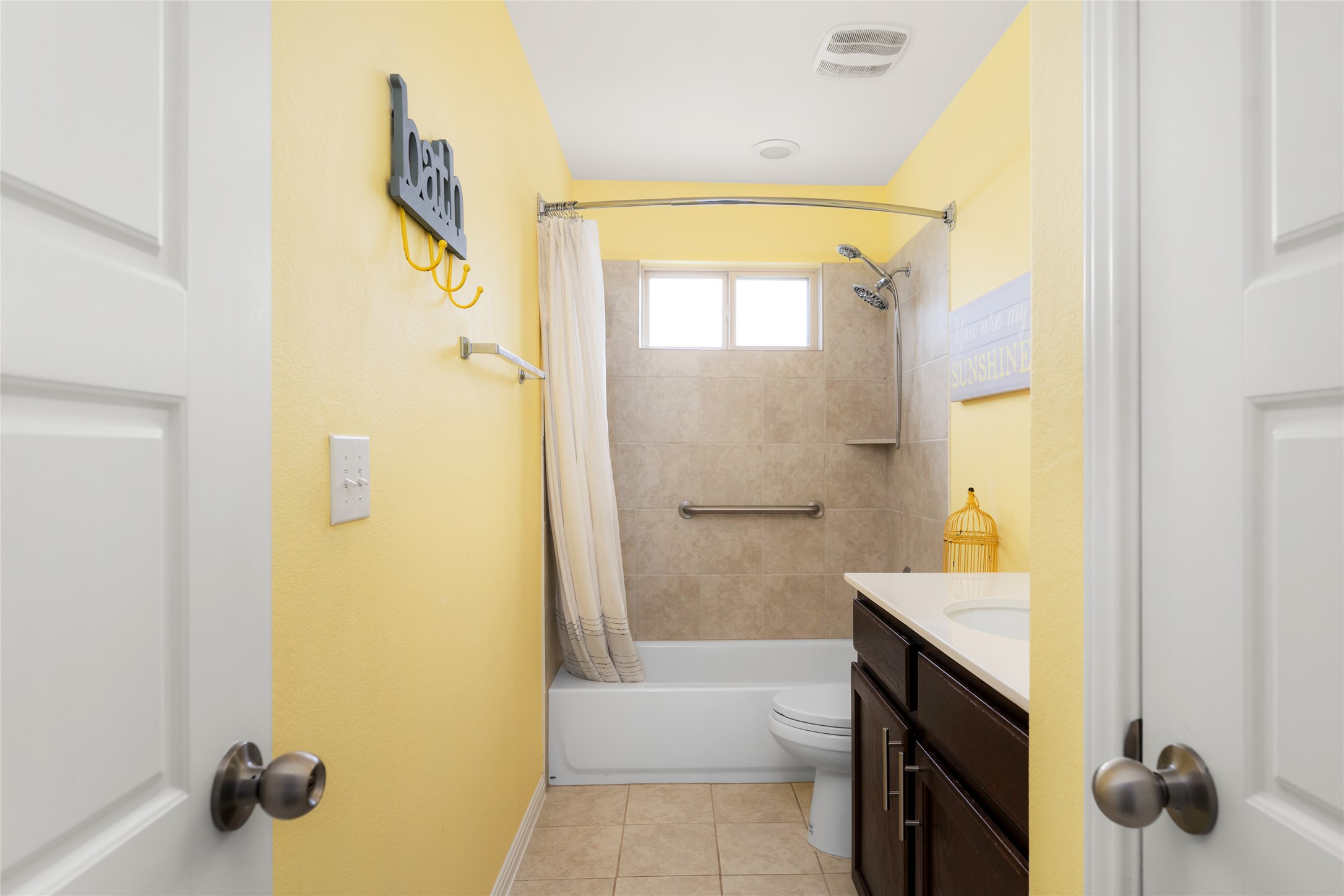 249 Wapiti Road Buda, TX 78610 - Photo 16 of 21 A compact bathroom offers essential functionality with a tiled tub/shower combination and practical vanity.