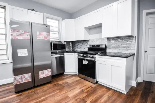 a kitchen with stainless steel appliances a refrigerator sink and microwave