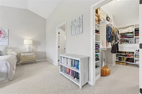 a bedroom with furniture and a book shelf