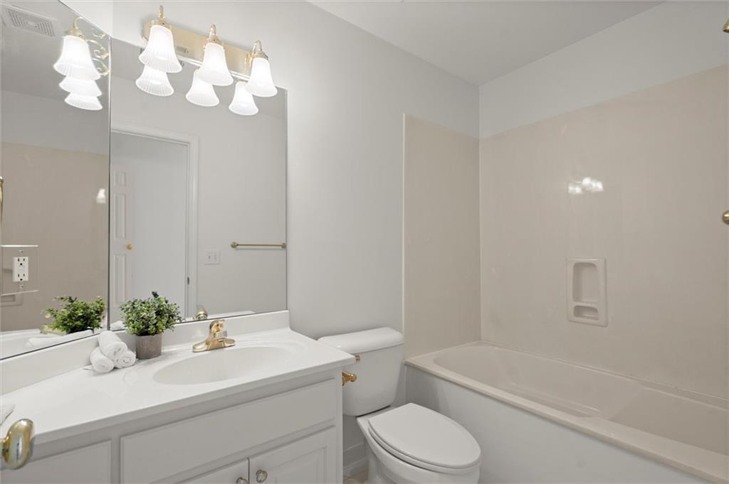 1200 Bay Pointe Terrace Alpharetta, GA 30005 - Photo 26 of 56 a bathroom with a sink a toilet a mirror and shower