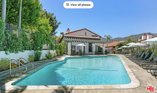 swimming pool view with a seating space