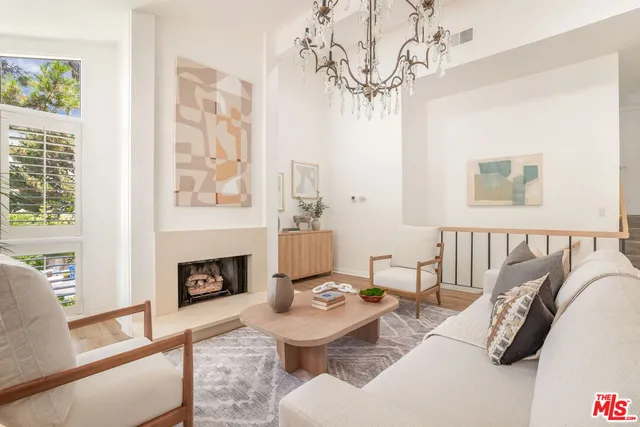 a living room with furniture a fireplace and a table