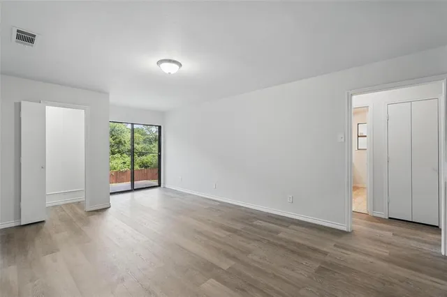 a living room with stainless steel appliances furniture and a large window