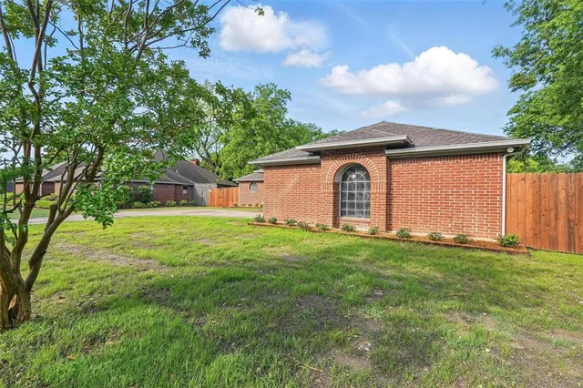 a front view of house with yard and trees
