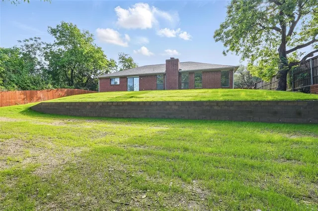 a view of a house with pool and a yard
