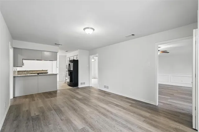 a view of an empty room with a window and fireplace