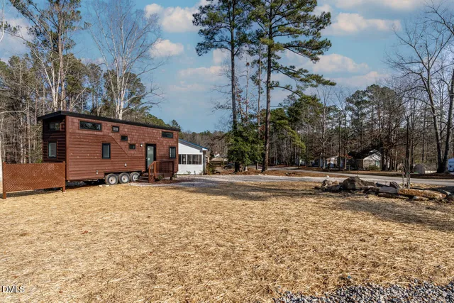 a view of a yard with a house and a tree
