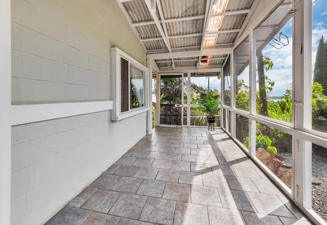 a view of a porch with wooden floor and windows