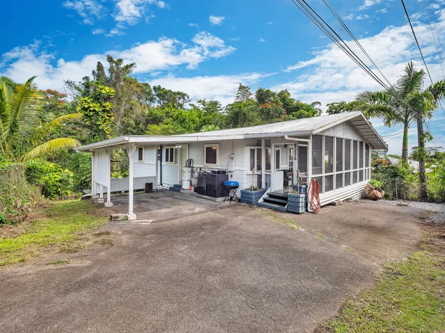 a view of a house with a patio and a yard