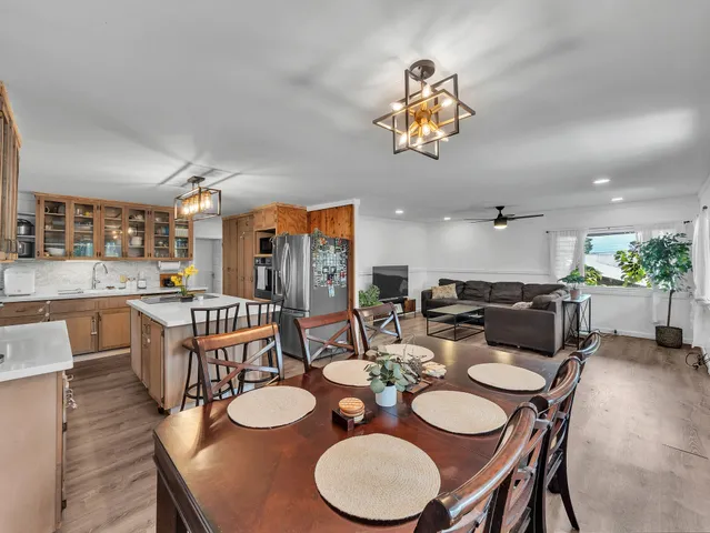 a dining room with furniture a rug and wooden floor