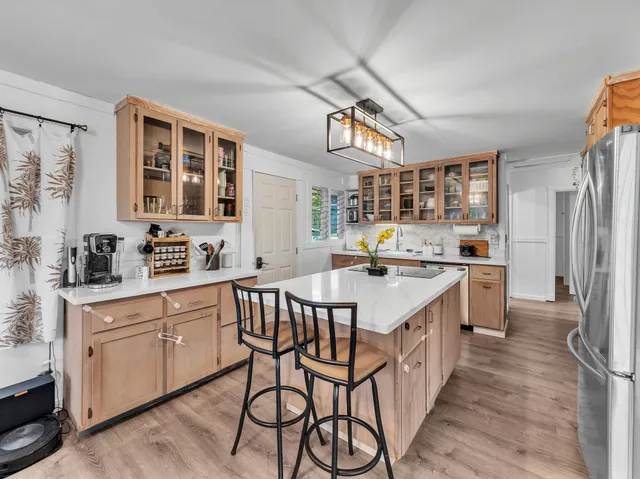 a kitchen with a sink stove and cabinets