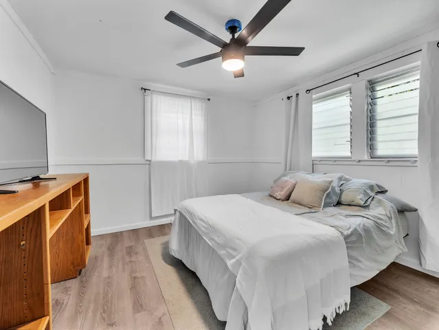 a bedroom with a bed and a television