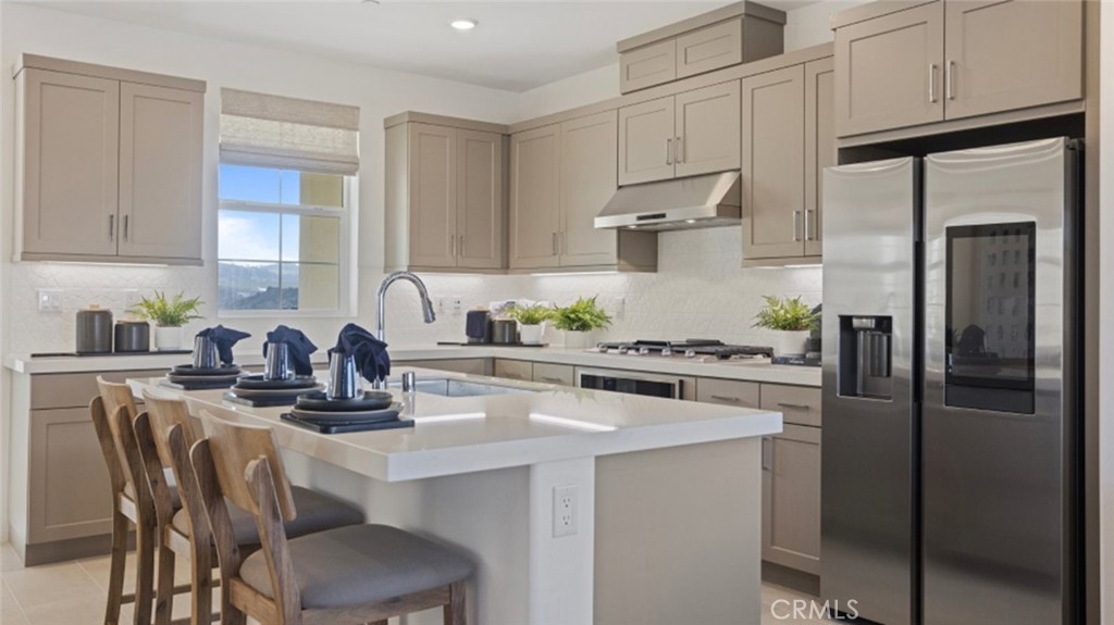 1331 Windmill Road Rancho Mission Viejo, CA 92694 - Photo 1 of 1 a kitchen with refrigerator a stove a sink and white cabinets