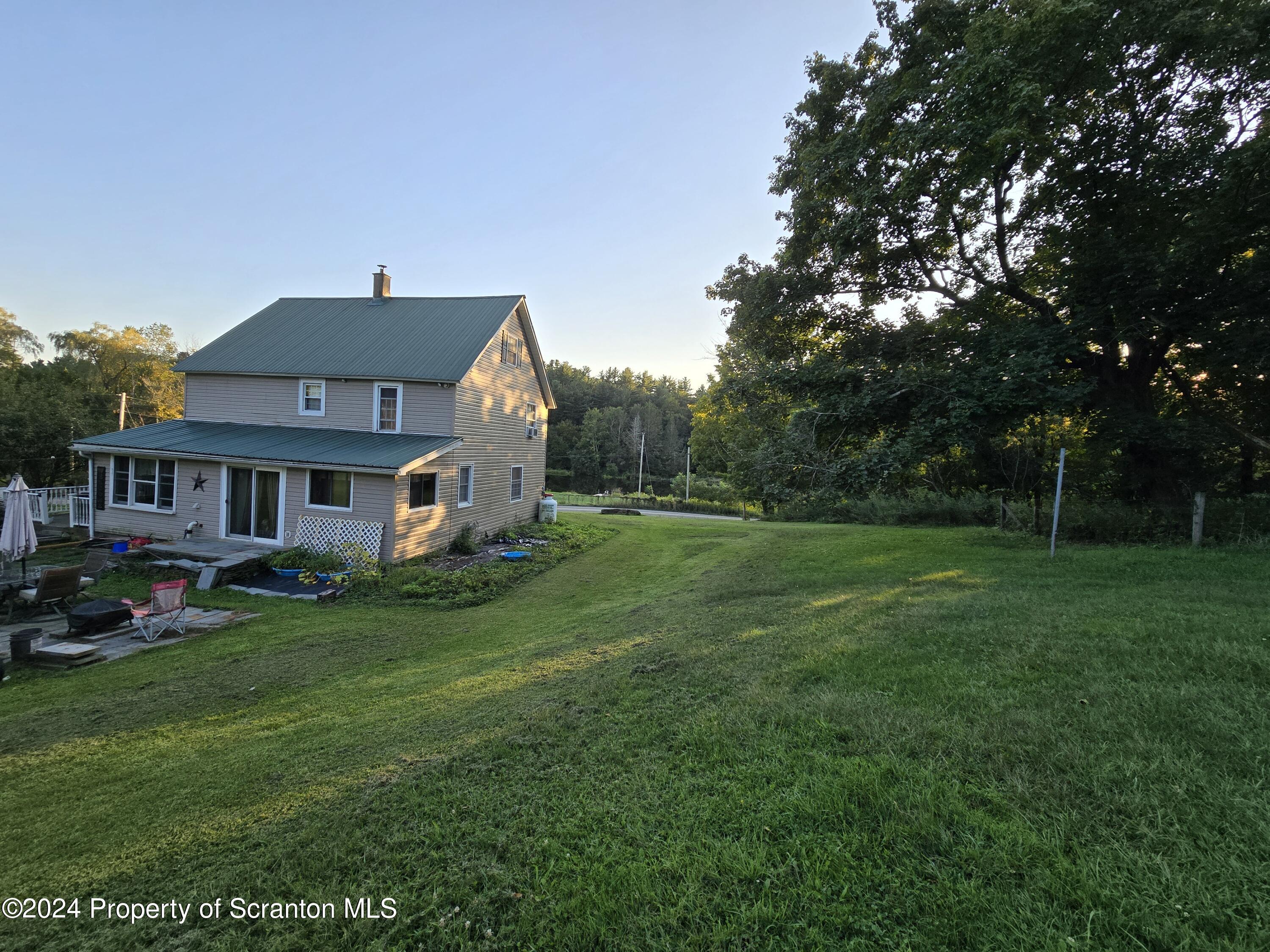 13899 Dimock To Nicholson Road Hop Bottom, PA 18824 - Photo 3 of 27 a front view of a house with a garden