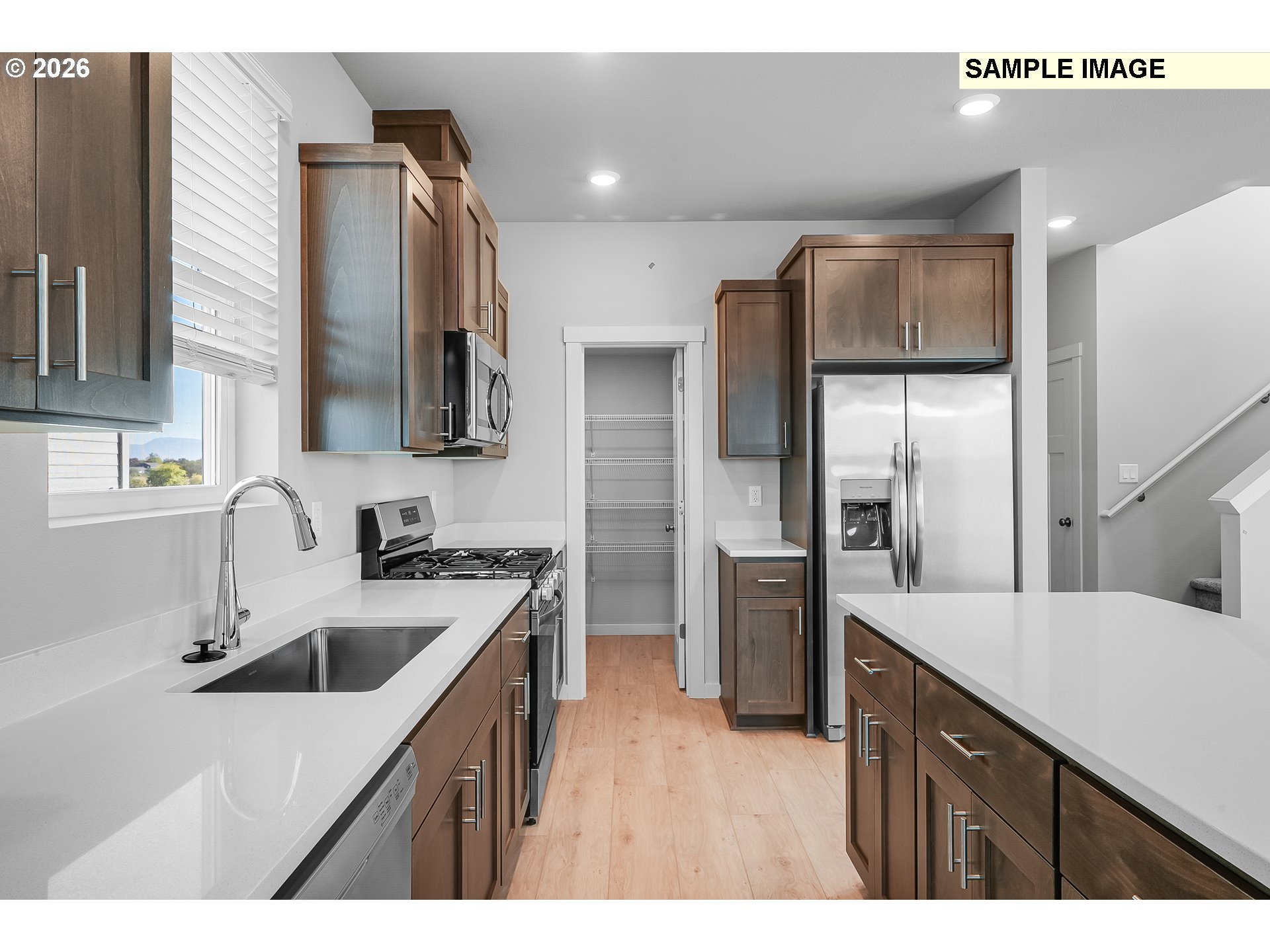 1092 Legacy Street Eugene, OR 97402 - Photo 6 of 20 a kitchen with a sink refrigerator and microwave