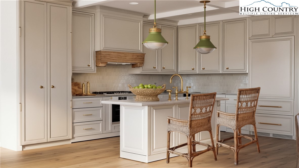 The Raynor Condos, Unit 2D Blowing Rock, NC 28605 - Photo 5 of 22 a kitchen with stainless steel appliances granite countertop a white cabinets and stove top oven