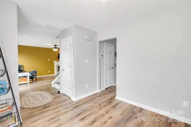 a view of a livingroom with wooden floor and a flat screen tv