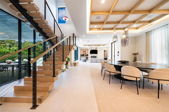 a kitchen with a table chairs refrigerator and microwave