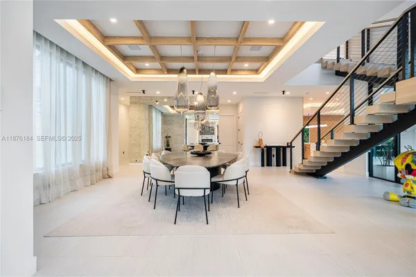 a view of living room filled with furniture and flat screen tv
