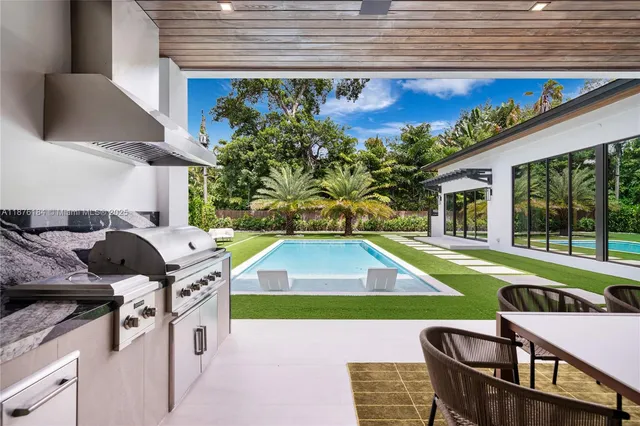 a kitchen with stainless steel appliances a stove top oven a sink a counter space and cabinets