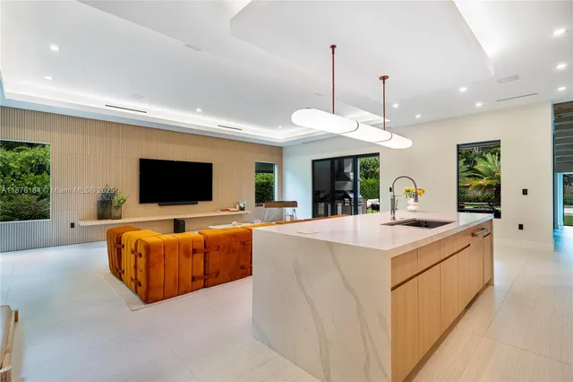 a view of a swimming pool with couches chairs and a big yard