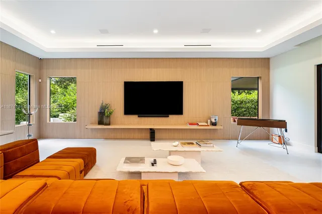 a view of a livingroom with furniture and a car garage