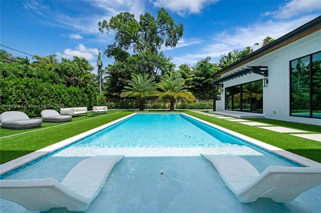a view of a balcony with two chairs and a table