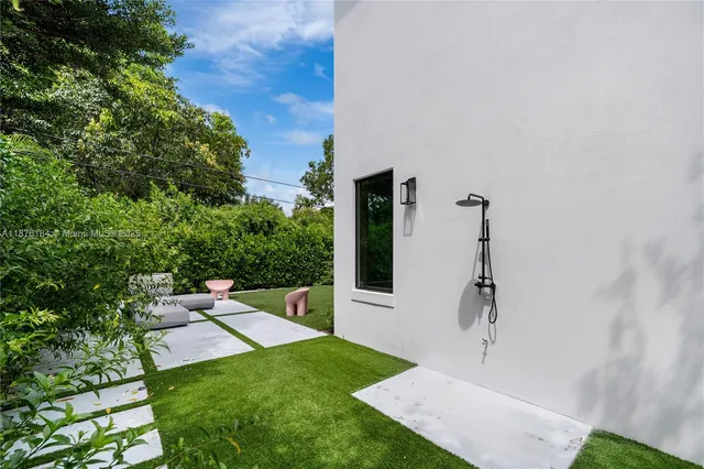a living room with lots of furniture and a large window